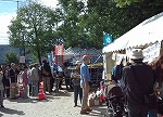 塀の奥がナゴヤ球場（中川図書館・富田図書館　「中川区民まつりに参加しました」）