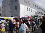 駅ちかウォーキング参加の皆さんが絶えず前を通られます。（中川図書館　「はくちゃん夢の朝市」）