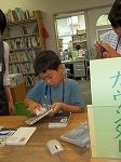 1さつ1さつていねいに...カウンター体験も楽しそうです。（くすのき図書館　くすのき図書館で自由研究【1】「体験！こども司書」）